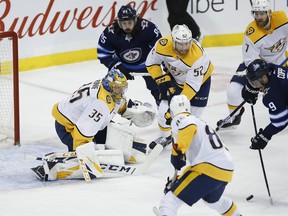 Winnipeg Jets' Andrew Copp tries to shoot on Nashville Predators goaltender Pekka Rinne at Bell MTS Place on Friday night. (The Canadian Press)