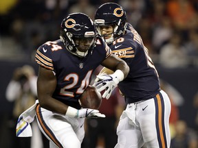 Chicago Bears quarterback Mitchell Trubisky (10) hands off the ball to running back Jordan Howard against the Minnesota Vikings, Monday, Oct. 9, 2017, in Chicago. (AP Photo/Darron Cummings)