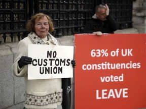 Pro-Brexit supporters protest outside the Houses of Parliament in London, Monday, March 18, 2019.