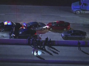 In this still image taken from video provided by courtesy of KABC-TV, a suspect's car is stopped after he led police through a bizarre and reckless chase swerving on roads and attempting to hit several cars, including patrol vehicles, Friday, March 29, 2019, in Burbank, Calif. (KABC-TV via AP)