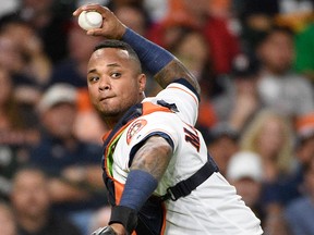 Houston Astros catcher Martin Maldonado attempts to throw out Oakland Athletics' Ramon Laureano during the second inning of a baseball game, Tuesday, Aug. 28, 2018, in Houston.