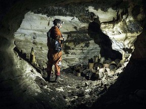Archaeologist Guillermo de Anda stands next to pre-columbian artifacts in a cave at the Mayan ruins of Chichen Itza, Yucatan, Mexico, Tuesday, Feb. 19, 2019. Mexican archaeologists say they have found a cave at the Mayan ruins of Chichen Itza with offerings of about 200 ceramic vessels in nearly untouched condition. The National Institute of Anthropology and History says the vessels appear to date back to around 1,000 A.D.