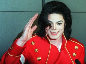 In this file photo taken on March 19, 1996, Michael Jackson waves to photographers during a press conference in Paris. (VINCENT AMALVY/AFP/Getty Images)