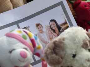 A photograph sits amid the tributes as they grow outside the home where a pregnant woman, Shanann Watts, and her two daughters, Bella and Celeste, lived Thursday, Aug. 16, 2018, in Frederick, Colo.