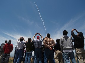 People watch a ground based interceptor missle take off at Vandenberg Air Force base, California on May 30, 2017. (GENE BLEVINS/AFP/Getty Images)