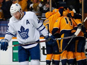 Maple Leafs’ Morgan Rielly skates away as the Predators celebrate a first-period goal on Tuesday night at Bridgestone Arena in Nashville. (GETTY IMAGES)