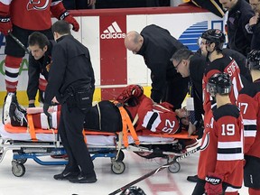 New Jersey Devils defenceman Mirco Mueller is wheeled off the ice on a stretcher after being injured during the third period of an NHL hockey game against the Calgary Flames Wednesday, Feb. 27, 2019, in Newark, N.J.