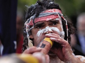 An aboriginal performer plays the didgeridoo guiding the march on ANZAC Day in Sydney's Redfern on April 25, 2008.