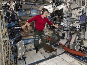 In this Jan. 18, 2019 photo made available by NASA, Flight Engineer Anne McClain looks at a laptop computer screen inside the U.S. Destiny laboratory module of the International Space Station.