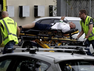 Ambulance staff take a man from outside a mosque in central Christchurch, New Zealand, Friday, March 15, 2019.