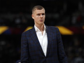 In this March 14, 2019, file photo, Dallas Mavericks forward Kristaps Porzingis stands during the second half of the team's NBA basketball game against the Denver Nuggets in Denver.