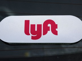 FILE - This Jan. 31, 2018 file photo shows a Lyft logo on a Lyft driver's car in Pittsburgh. Lyft set the price for its stock at $72 per share late Thursday, March 28, 2019, setting the stage for the ride-hailing pioneer's hotly anticipated stock market debut.