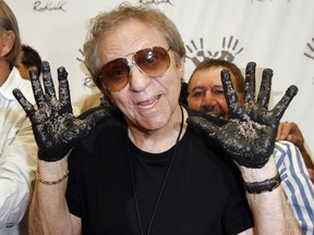 In this June 25, 2008, file photo, Hal Blaine holds up his hands covered in cement after placing them in wet cement with Don Randi and Glen Campbell, representing The Wrecking Crew following an induction ceremony for Hollywood's RockWalk in Los Angeles.