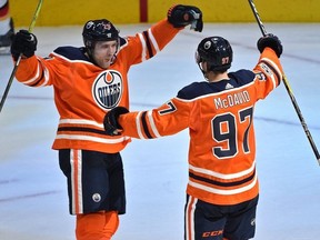 Edmonton Oilers Connor McDavid celebrates with Leon Draisaitl after scoring a hit trick against the Calgary Flames during the season opener of NHL action at Rogers Place in Edmonton, Oct. 4, 2017.