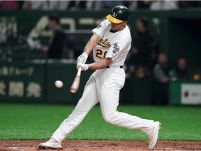 Infielder Matt Olson of the Oakland Athletics grounds to reach on a fielder's choice in the second inning during the game between Seattle Mariners and Oakland Athletics at Tokyo Dome on March 20, 2019 in Tokyo, Japan.
