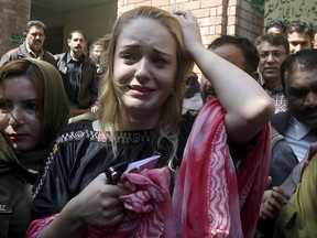 Czech model Tereza Hluskova, centre, reacts after appearing in court in Lahore, Pakistan, Wednesday, March 20, 2019.