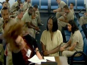 An inmate is seen punching an assistant public defender during a court proceeding.
