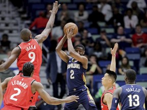 New Orleans Pelicans guard Ian Clark looks to pass to forward Cheick Diallo as he is guarded by Toronto Raptors centre Serge Ibaka, forward Kawhi Leonard and guard Jeremy Lin in the first half of an NBA basketball game in New Orleans, Friday, March 8, 2019.