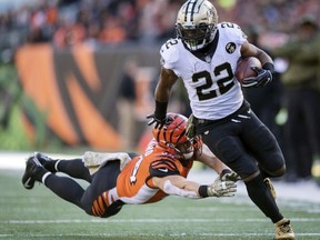 In this Nov. 11, 2018, file photo, New Orleans Saints running back Mark Ingram outruns the tackle of Cincinnati Bengals defensive end Sam Hubbard during the first half of an NFL football game in Cincinnati.
