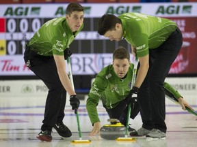 Saskatchewan skip Kirk Muyres throws a stone while Daniel Marsh (left) and Dallan Muyres sweep during weekend action the 2019 Brier in Brandon, Manitoba.