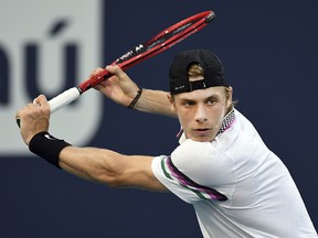 Denis Shapovalov returns a volley to Frances Tiafoe during the quarterfinals of the Miami Open, Thursday, March 28, 2019, in Miami Gardens, Fla. (AP Photo/Jim Rassol)