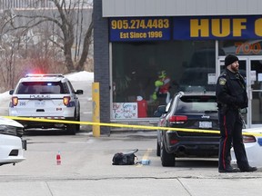 Peel Regional Police investigate the scene after a man was shot dead in a daylight shooting near Dundas and Cawthra in Mississauga on Monday March 11, 2019. Dave Abel/Toronto Sun