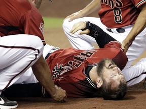Arizona Diamondbacks outfielder Steven Souza Jr. lies on the field after getting injured while scoring against the Chicago White Sox Monday, March 25, 2019, in Phoenix, Ariz. (AP Photo/Elaine Thompson)