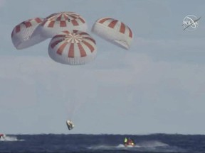 This image provided by NASA shows SpaceX's Dragon capsule carrying a test dummy splashed down into the Atlantic Ocean off the Florida coast, Friday, March 8, 2019.