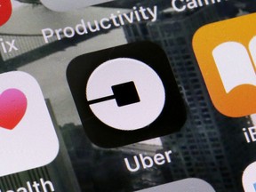 This June 12, 2018, file photo shows the Uber app on a phone in New York. Ride-hailing service Uber announced on Tuesday, March 26, 2019 it has acquired its Mideast competitor Careem for $3.1 billion, making it the largest-ever technology purchase in the region.