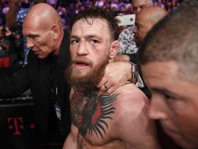 In this Oct. 6, 2018, file photo, Conor McGregor walks out of the arena after he was defeated by Khabib Nurmagomedov in a lightweight title mixed martial arts bout at UFC 229 in Las Vegas. Superstar UFC fighter McGregor has announced on social media that he is retiring from mixed martial arts. McGregor's verified Twitter account had a post early Tuesday, March 26, 2019,  that said the former featherweight and lightweight UFC champion was making a "quick announcement."