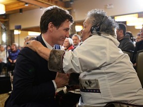 Prime Minister Justin Trudeau is greeted by an Inuit Elder prior to delivering an official apology to Inuit for the federal government's management of tuberculosis in the Arctic from the 1940s to the 1960s during an event in Iqaluit, Nunavut on Friday, March 8, 2019.