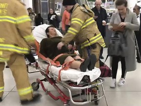 In this still image taken from video provided by WNBC-TV News 4 New York, emergency medical personnel tend to an injured passenger from a Turkish Airlines flight at New York's John F. Kennedy International Airport, Saturday, March 9, 2019. (WNBC-TV News 4 New York via AP)