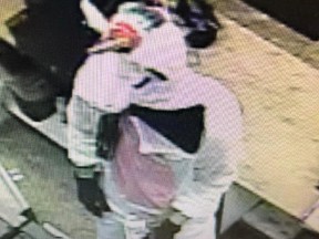 This photo provided by Baltimore County police shows surveillance video of an armed robbery with a suspect dressed in the unicorn costume. (Baltimore County police via AP)