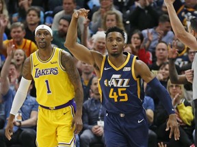 Utah Jazz guard Donovan Mitchell celebrates after scoring 3-pointer against Los Angeles Lakers guard Kentavious Caldwell-Pope during the first half of an NBA game Wednesday, March 27, 2019, in Salt Lake City.
