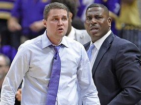 In this photo taken Feb. 23, 2019, LSU head coach Will Wade, left, and assistant coach Tony Benford, right, watch a game in Baton Rouge, La. (AP Photo/Bill Feig)