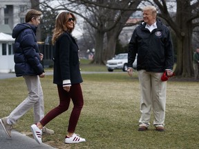 In this March 8, 2019 file photo, U.S. President Donald Trump waits for his son Barron Trump, and first lady Melania Trump after speaking with reporters outside the White House in Washington before travelling to Alabama to visit areas affected by the deadly tornadoes.