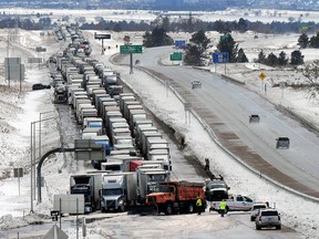 Trucks line I-25 south of Baptist Rd. Thursday, March 14, 2019 in Colorado Springs, Colo.