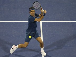 Roger Federer returns the ball to Stefanos Tsitsipas during their final match at the Dubai Duty Free Tennis Championship, in Dubai, United Arab Emirates, Saturday, March 2, 2019.