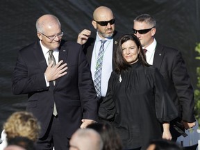 Australian Prime Minister Scott Morrison, left, and his wife Jenny arrive at the national remembrance service in Hagley Park for the victims of the March 15 mosques terrorist attack in Christchurch, New Zealand, Friday, March 29, 2019.