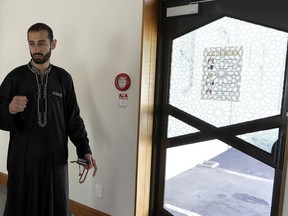 In this March 27, 2019, photo, Al Noor mosque volunteer Khaled Alnobani gestures as explains his escape through a glass door panel when a gunman burst into the mosque on March 15 in Christchurch, New Zealand.