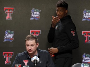 Texas Tech's Jarrett Culver (right) walks in as head coach Chris Beard answers questions during a news conference on Sunday.