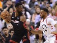 Miami Heat guard Dwyane Wade looks for a pass as Toronto Raptors' Norm Powell defends during Sunday's game.