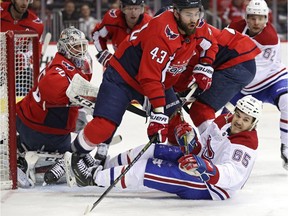 Canadiens' Andrew Shaw battles Tom Wilson in front of Capitals goalie Braden Holtby Thursday night in Washington.