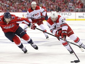 Greg McKegg #42 of the Carolina Hurricanes skates past Nick Jensen #3 of the Washington Capitals in the third period in Game Five of the Eastern Conference First Round during the 2019 NHL Stanley Cup Playoffs at Capital One Arena on April 20, 2019 in Washington, DC.