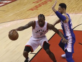 Toronto Raptors' Kawhi Leonard dribbles in the key looking to score during Saturday's win over the 76ers. (JACK BOLAND/Toronto Sun)