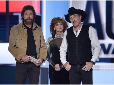 Ronnie Dunn, left, and Kix Brooks, right, of Brooks & Dunn, and host Reba McEntire present the award for entertainer of the year at the 54th annual Academy of Country Music Awards at the MGM Grand Garden Arena on Sunday, April 7, 2019, in Las Vegas.
