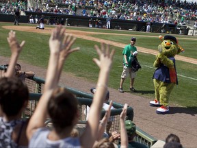 In this March 17, 2013, file photo, Orbit, the Houston Astros' mascot, fires a T-shirt gun during the sixth inning of the team's spring training baseball game against the Toronto Blue Jays in Kissimmee, Fla. (AP Photo/Evan Vucci, File)
