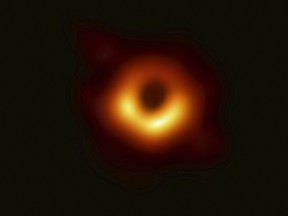 This false-colour image released Wednesday, April 10, 2019 by the Event Horizon Telescope shows a black hole at the center of the Messier 87 galaxy. (Event Horizon Telescope Collaboration/Maunakea Observatories via AP)