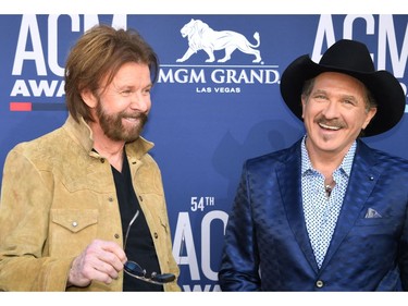 Kix Brooks (R) and Ronnie Dunn of the musical duo Brooks & Dunn arrive for the 54th Academy of Country Music Awards on April 7, 2019, at the MGM Grand Garden Arena in Las Vegas.
