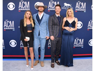 Tyler Hubbard (2nd R) and Brian Kelley (2nd L) of US musical duo Florida Georgia Line and their wives Brittney Kelley (L) and Hayley Hubbard arrive for the 54th Academy of Country Music Awards on April 7, 2019, at the MGM Grand Garden Arena in Las Vegas, Nevada.